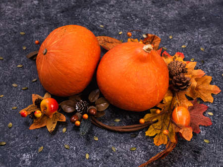 Pumpkins festive autumn decor with fall leaves on a grey background.の写真素材