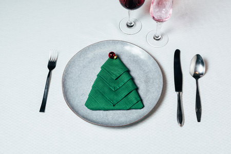 Christmas table setting with ceramic dishware, silver tablewareの写真素材