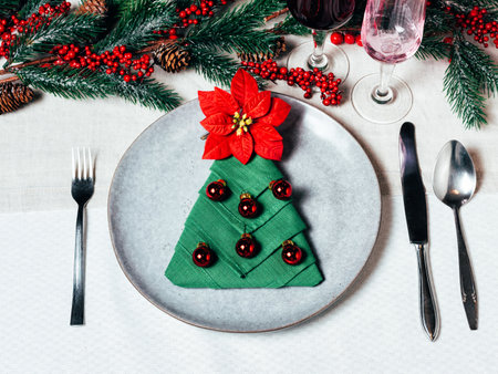 Christmas table setting with ceramic dishware, silver tablewareの写真素材
