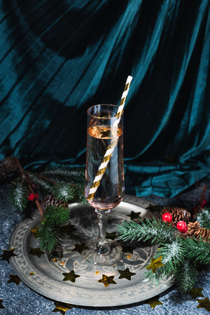 Pink flute glass of champagne with golden paper strawの写真素材