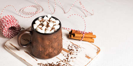Rustic ceramic mug with a hot chocolate cocoa drink with marshmallows.の写真素材