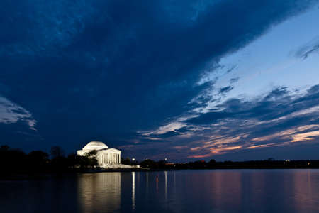 Thomas Jefferson Memorial with reflecting in the Tidal Basin in Washington DC at dusk shortly after sunset with dramatic skiesのeditorial素材
