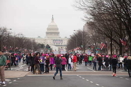 Women gather on Pennsylvania Avenue, NW, with the United States Capitol in the background to protest President Trump's positions on women's and other human rights.のeditorial素材