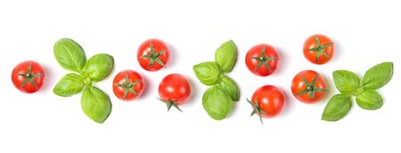 Beautiful border made of fresh cherry tomatoes with basil leaves, isolated on white background, vegetable pattern, top viewの写真素材