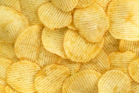 Potato chips, food background, top viewの写真素材