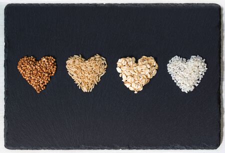 Buckwheat, brown rice, oatmeal and milk rice in a shapes of heartsの写真素材