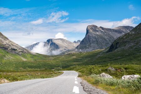 Mountain asphalt road surrounded by mountains, on the way to Trollstigen, Norwayの写真素材