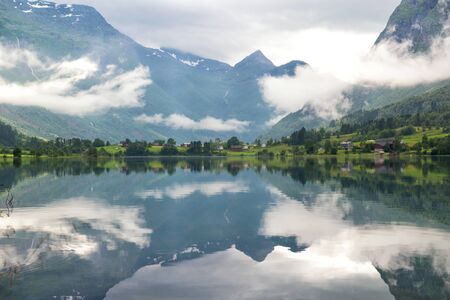 Rural lake landscape with mountains and clouds, Norwayの写真素材