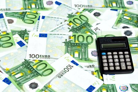 One hundred Euro banknotes and calculator, money background