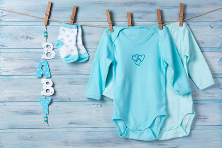 Baby clothes, little socks and word baby on a clotheslineの写真素材