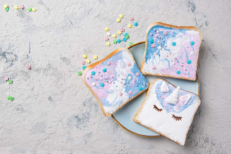 Unicorn or mermaid toasts with stars on a plate, food for kids idea, top viewの写真素材