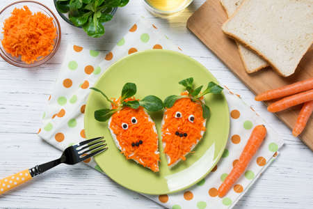 Funny toasts in a shape of carrots, food for kids Easter idea, top viewの写真素材