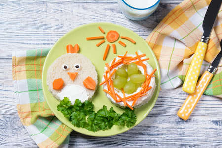 Funny toast in a shape of chick and nest with eggs, sandwich for kids Easter idea, top viewの写真素材