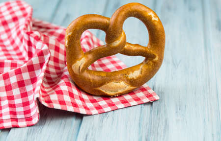German fresh baked salty bretzel on wooden background