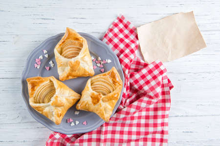 Sweet pastries in the shape of an envelope with heart filled with apples, dessert for Valentine's Day or Mother's day, top viewの写真素材
