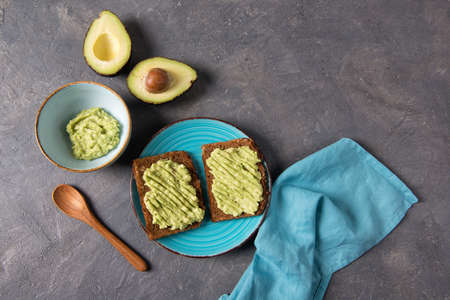 Avocado toasts on whole grain bread, mashed avocado with lime, healthy eating concept, top viewの写真素材
