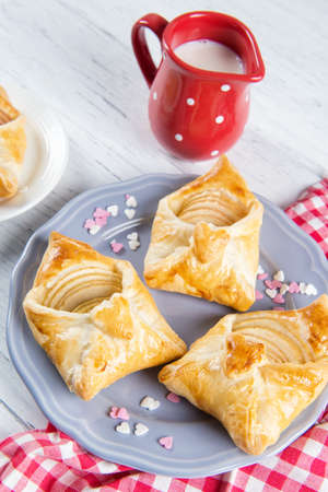 Sweet pastries in the shape of an envelope with heart filled with apples, dessert for Valentine's or Mother's dayの写真素材