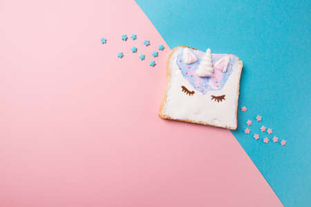 Unicorn toast with stars, food for kids idea, top view on a blue and pink backgroundの写真素材