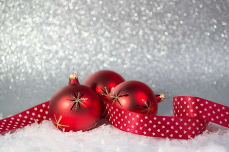 Christmas background with red balls on a snow