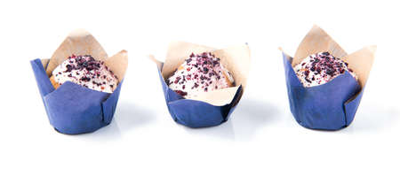 Homemade blueberry muffins with white chocolate in a row isolated on white backgroundの写真素材