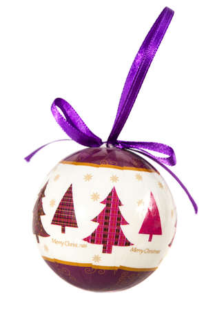 Christmas ball with Merry Christmas slogan and trees, isloated on white backgroundの写真素材