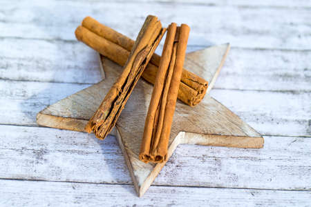 Three dry cinnamon sticks on wooden starの写真素材