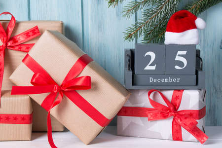 Christmas block calendar with 25 December and gift boxes, wooden backgroundの写真素材