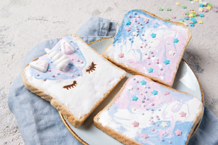 Unicorn toasts with marshmallow and stars on a plate, food for kids ideaの写真素材