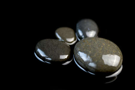 Trace feet made of a pebble stones on black background