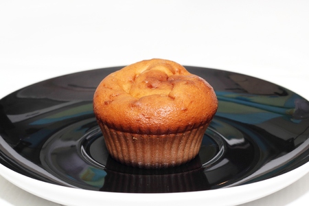 muffins with tea or coffee on white tableの写真素材