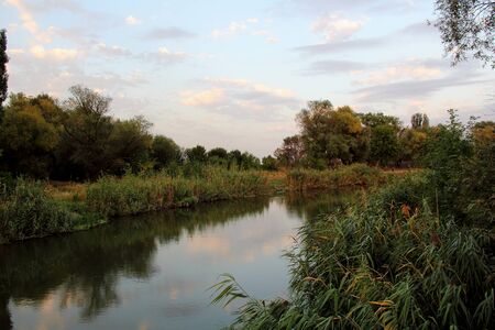 Autumn landscape. River bank on sunsetの写真素材