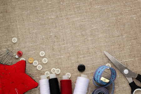 pin cushion with needles,thread and buttons for sewing with space for inscriptionsの写真素材