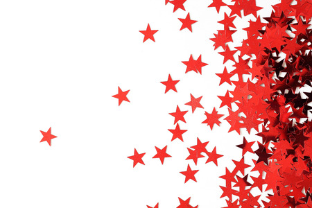 many red stars confetti on white backgroundの写真素材
