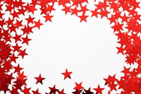 many red stars confetti on white backgroundの写真素材