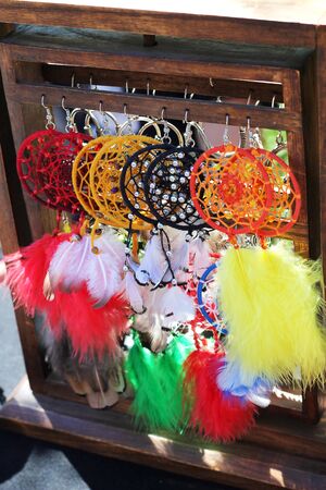 Dreamcatchers for sale in market, with other handicrafts in backgroundの写真素材