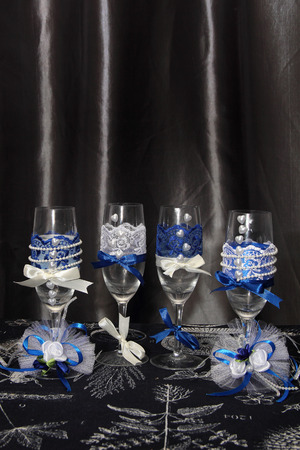 Two glasses decorated with flowers for a wedding reception in blue tonesの写真素材