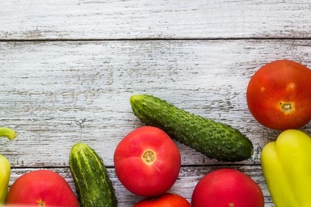 Top view of fresh vegetables and spices on light wooden background with space for textの写真素材