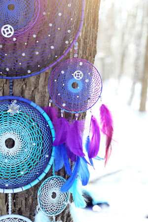 photo of a dreamcatcher made by hand, with using threads, beads and feathers roosterの写真素材