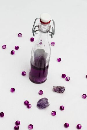 Aromatherapy oil in bottles with fresh lavenders on white backgroundの写真素材