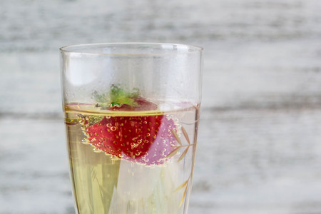 champagne glasses and strawberries on white backgroundの写真素材