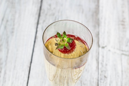 champagne glasses and strawberries on white backgroundの写真素材