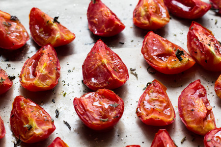 Sun dried tomatoes on white baking paper view from aboveの写真素材