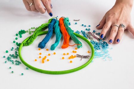 set for making a Dreamcatcher, beads, thread on a white backgroundの写真素材