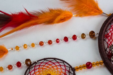 Beautiful orange dream catcher on white backgroundの写真素材