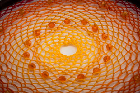 Beautiful orange dream catcher on white backgroundの写真素材