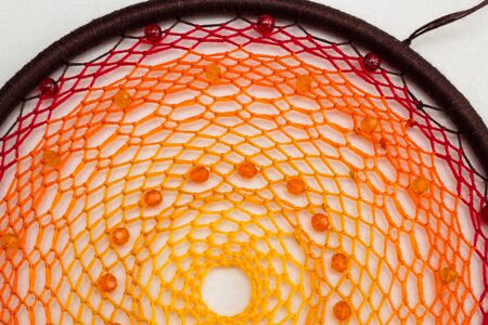 Beautiful orange dream catcher on white backgroundの写真素材