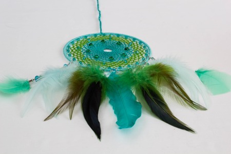 green feathers of dreamcatcher on white backgroundの写真素材