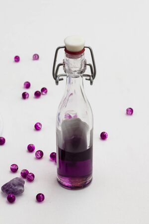 Aromatherapy oil in bottles with fresh lavenders on white backgroundの写真素材