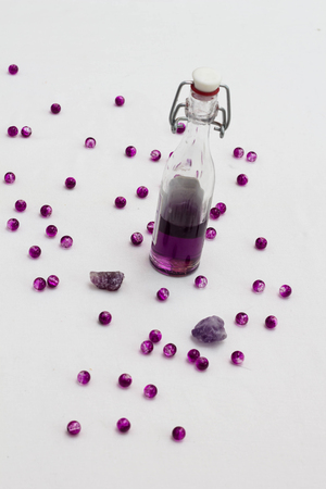 Aromatherapy oil in bottles with fresh lavenders on white backgroundの写真素材