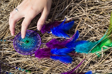 photo of a dreamcatcher made by hand, with using threads, beads and feathers roosterの写真素材